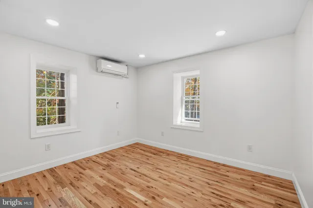 a view of a livingroom with wooden floor and closet area