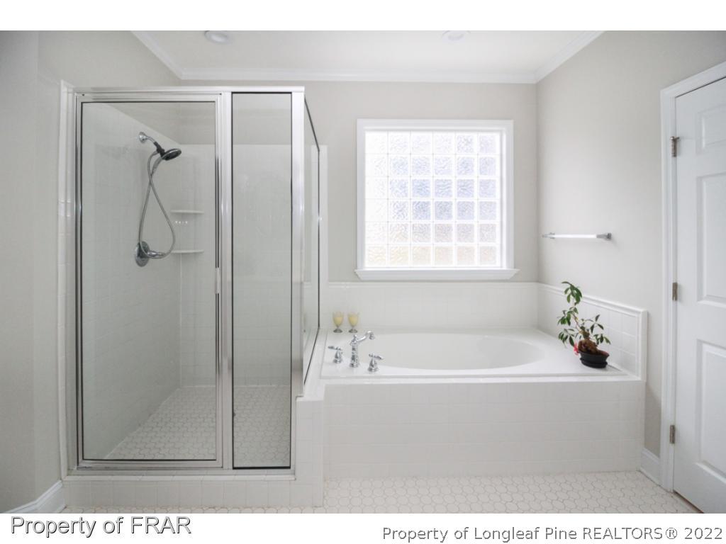 384 Booth Pond Road Raeford, NC 28376 - Photo 17 of 35 a bathroom with a tub shower and a sink