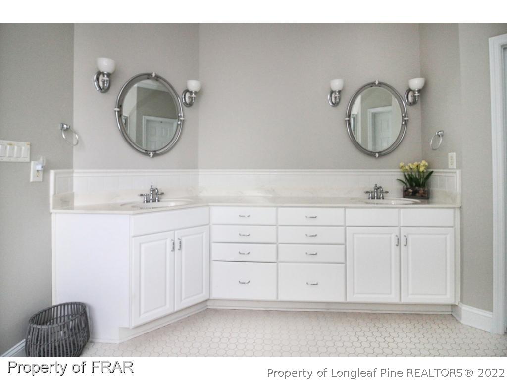 384 Booth Pond Road Raeford, NC 28376 - Photo 18 of 35 a bathroom with a double vanity sink and a mirror