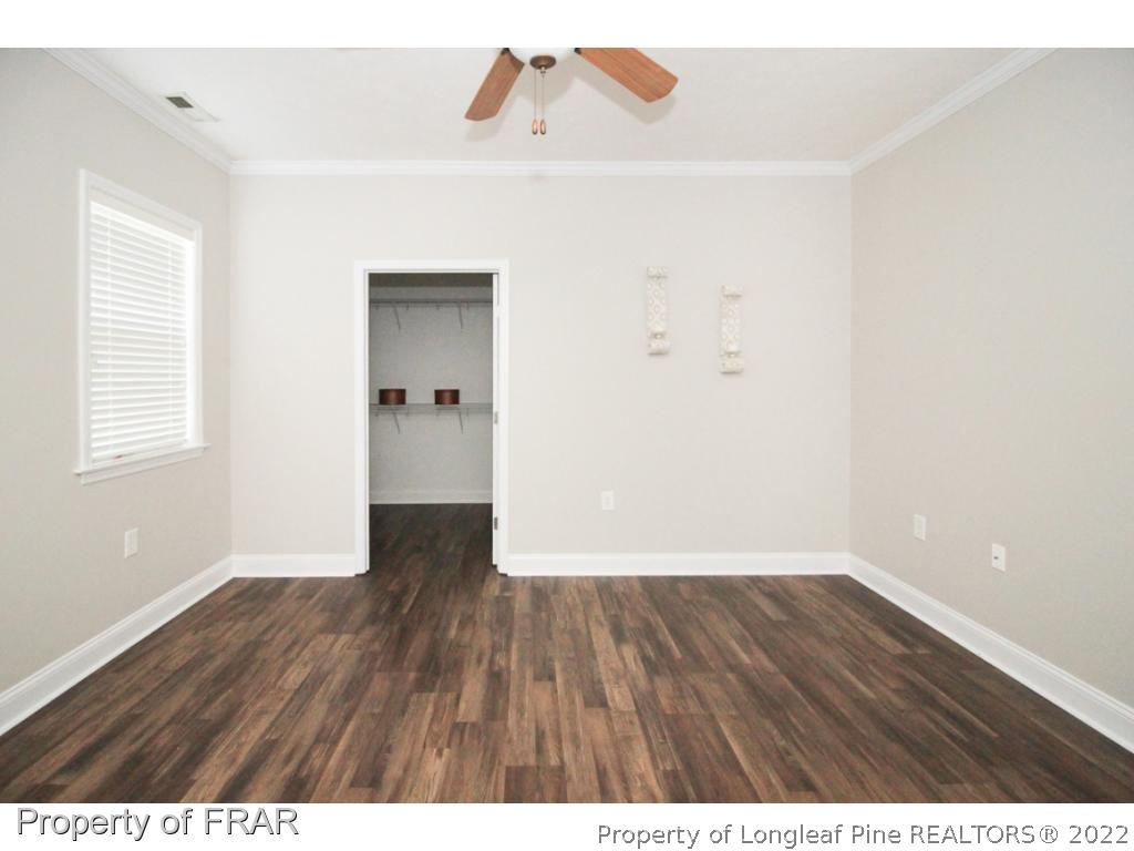 384 Booth Pond Road Raeford, NC 28376 - Photo 20 of 35 a view of an empty room with wooden floor and a window