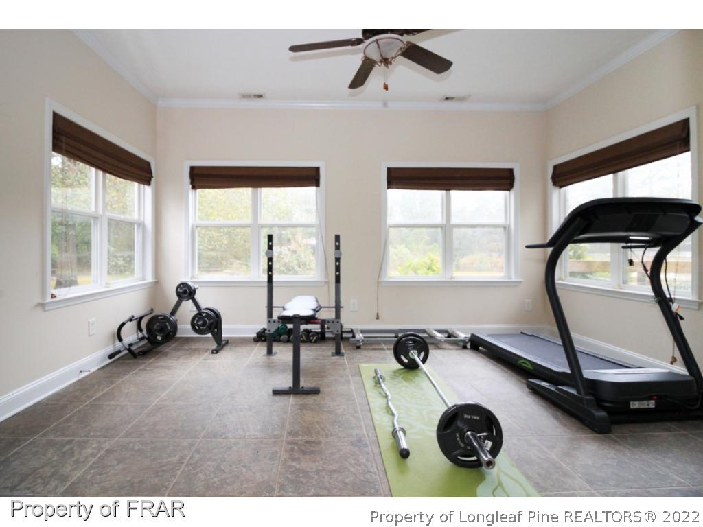 384 Booth Pond Road Raeford, NC 28376 - Photo 29 of 35 a room with gym equipment and a large window