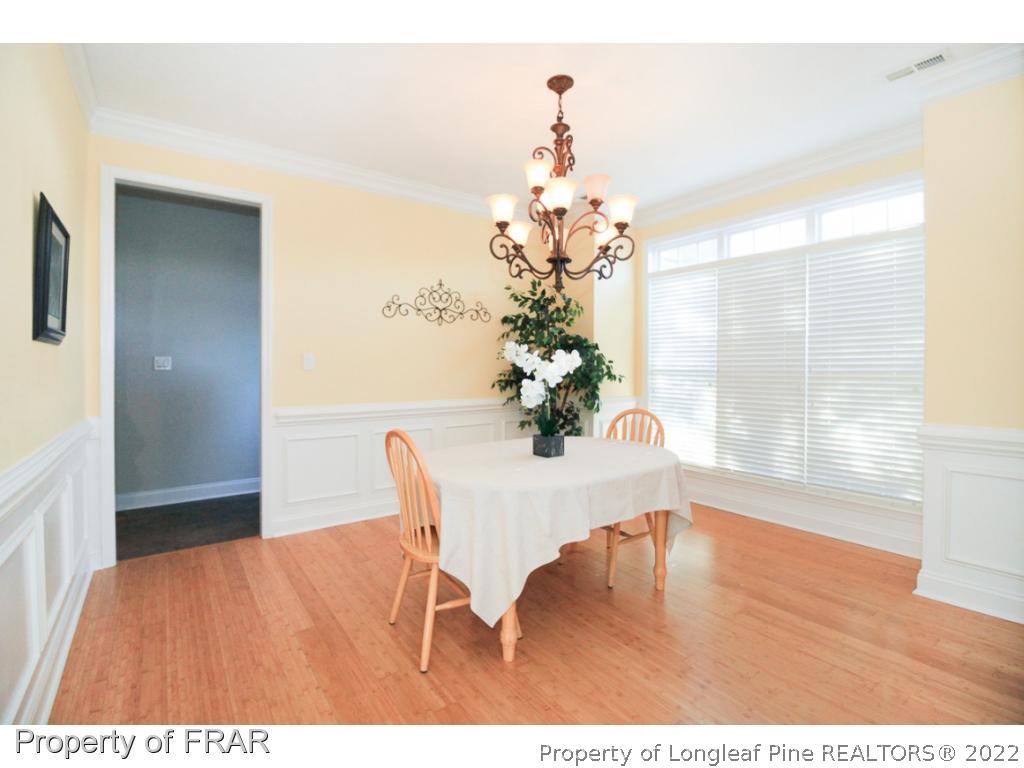384 Booth Pond Road Raeford, NC 28376 - Photo 4 of 35 a view of a dining room with furniture and wooden floor