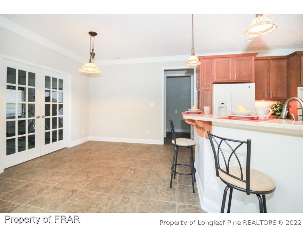 384 Booth Pond Road Raeford, NC 28376 - Photo 8 of 35 a kitchen with a sink cabinets and dining table