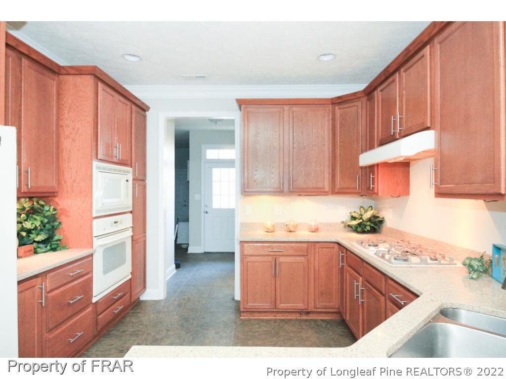 384 Booth Pond Road Raeford, NC 28376 - Photo 10 of 35 a kitchen with a sink stove and cabinets