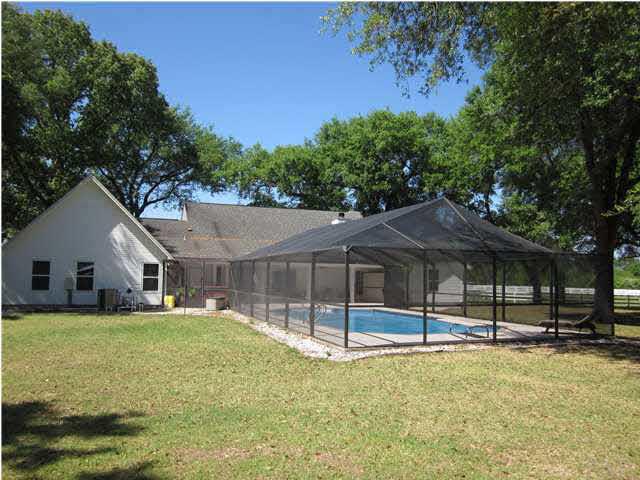 5170 Annie Ruth Street Milton, FL 32570 - Photo 16 of 24 Rear of Main House with View of Screened Enclosed Pool