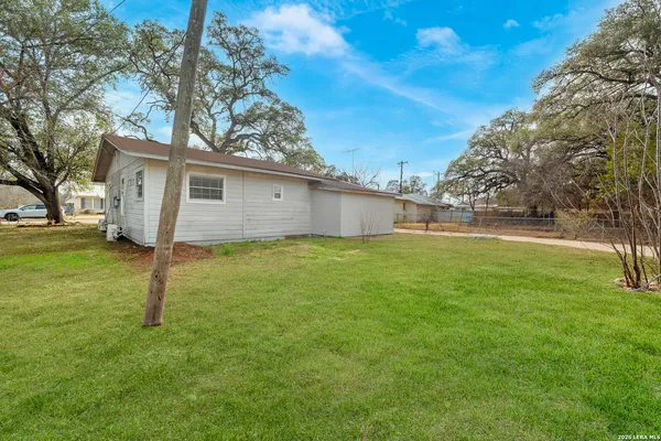 a front view of house with yard and trees