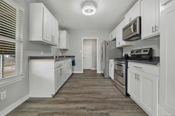 a kitchen with stainless steel appliances granite countertop a stove and a refrigerator