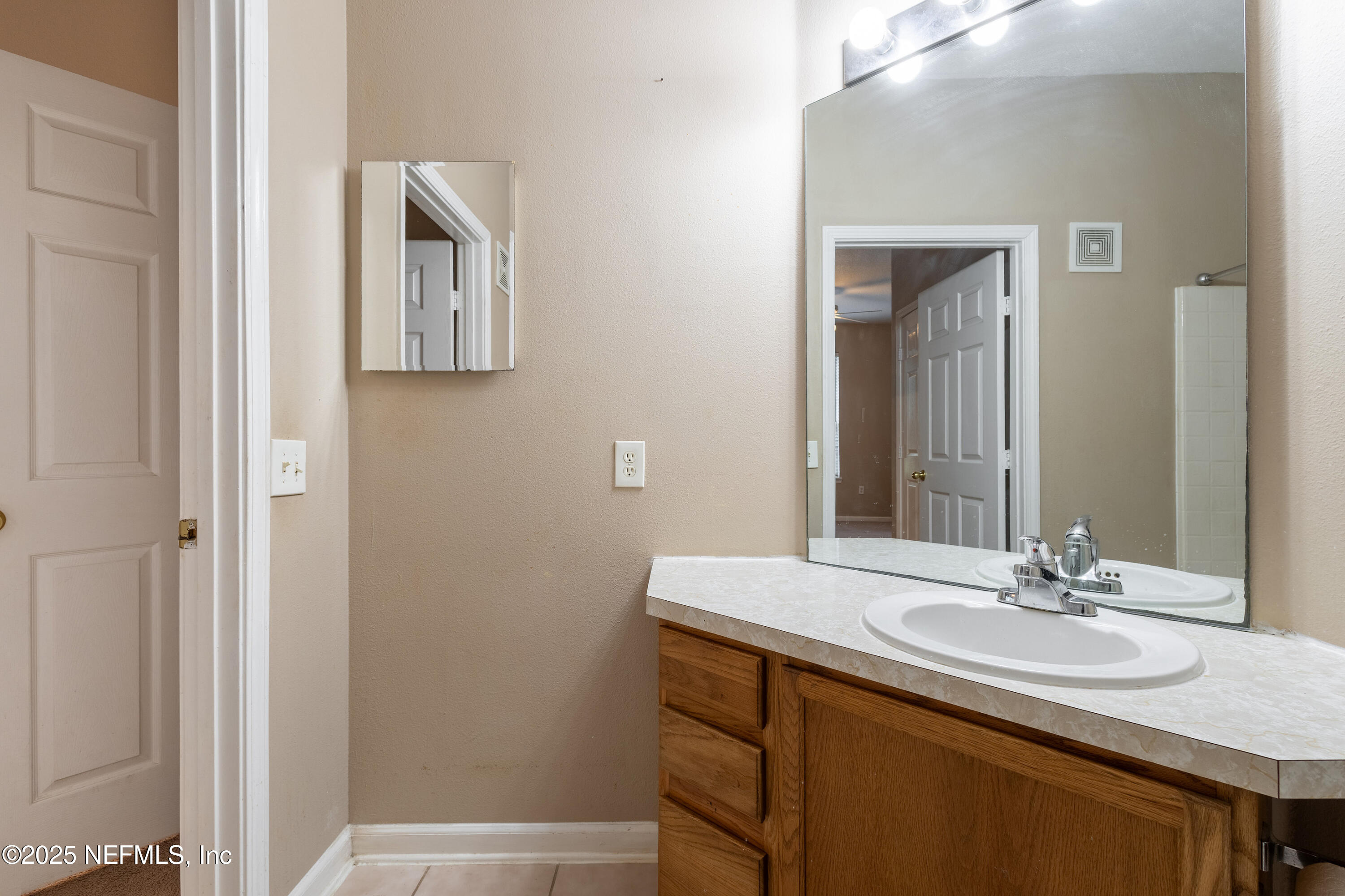 10550 Baymeadows Road, Unit 610 Jacksonville, FL 32256 - Photo 17 of 35 a bathroom with a sink and a mirror