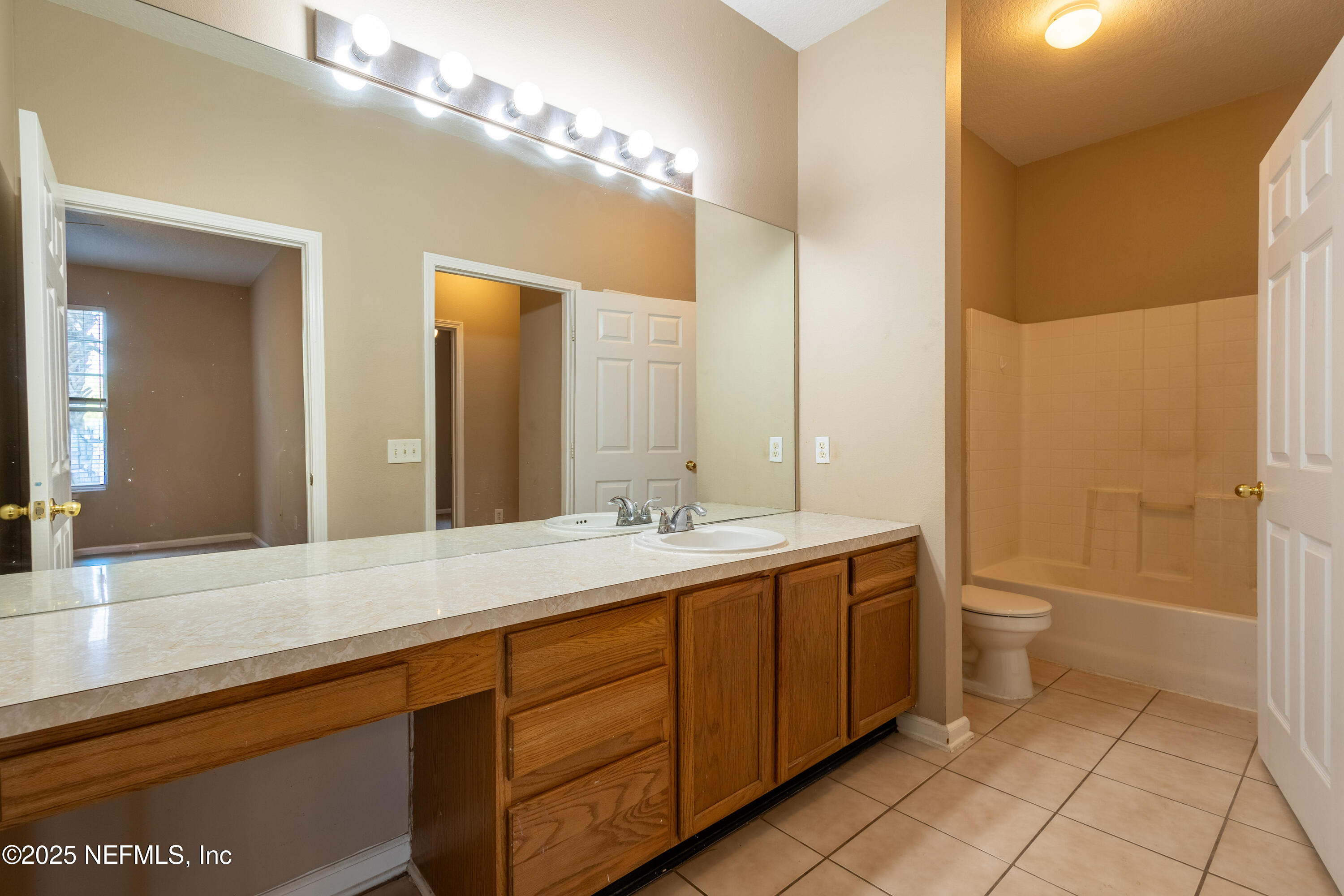10550 Baymeadows Road, Unit 610 Jacksonville, FL 32256 - Photo 23 of 35 a bathroom with a double vanity sink and a mirror