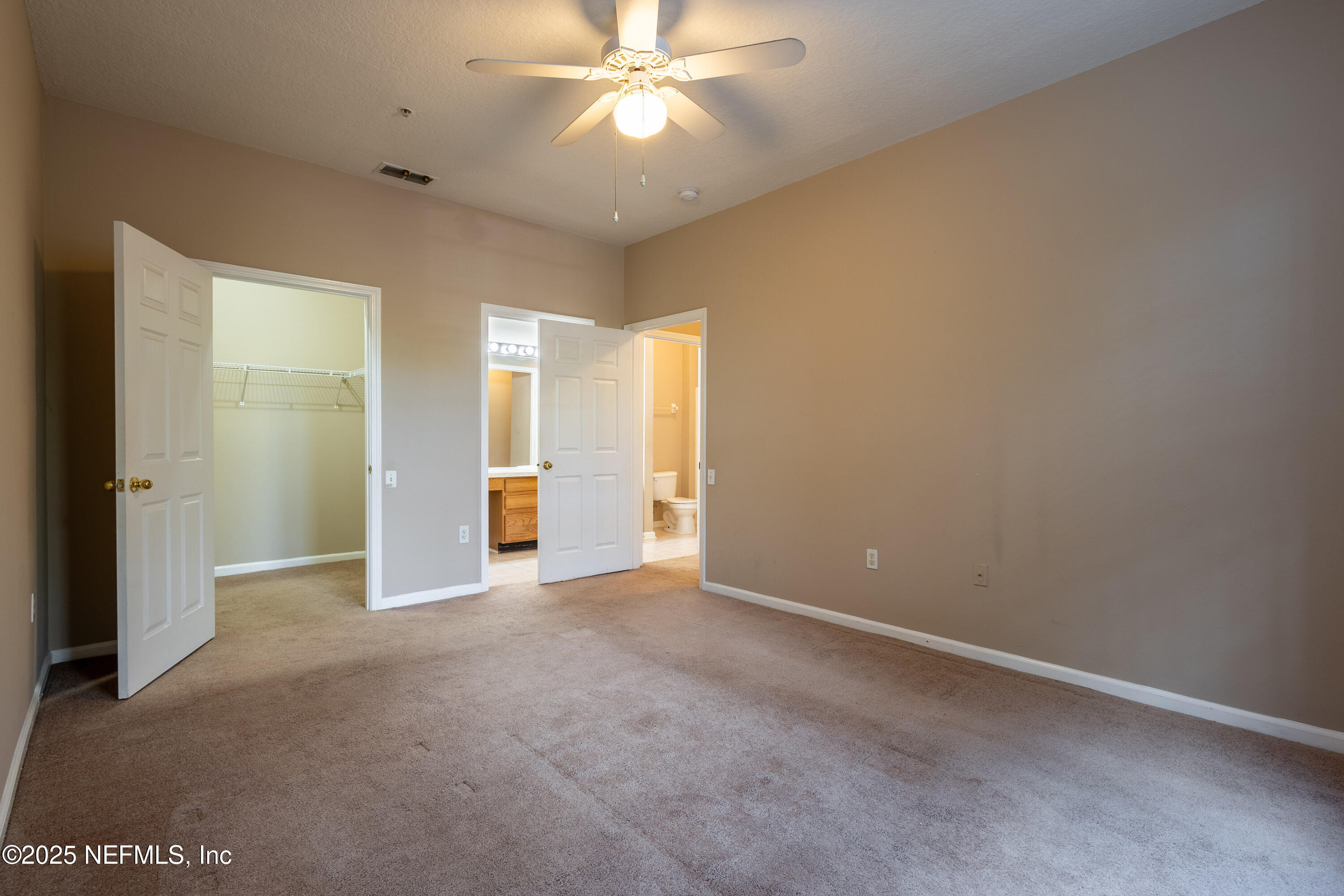 10550 Baymeadows Road, Unit 610 Jacksonville, FL 32256 - Photo 24 of 35 an empty room with closet and a chandelier fan