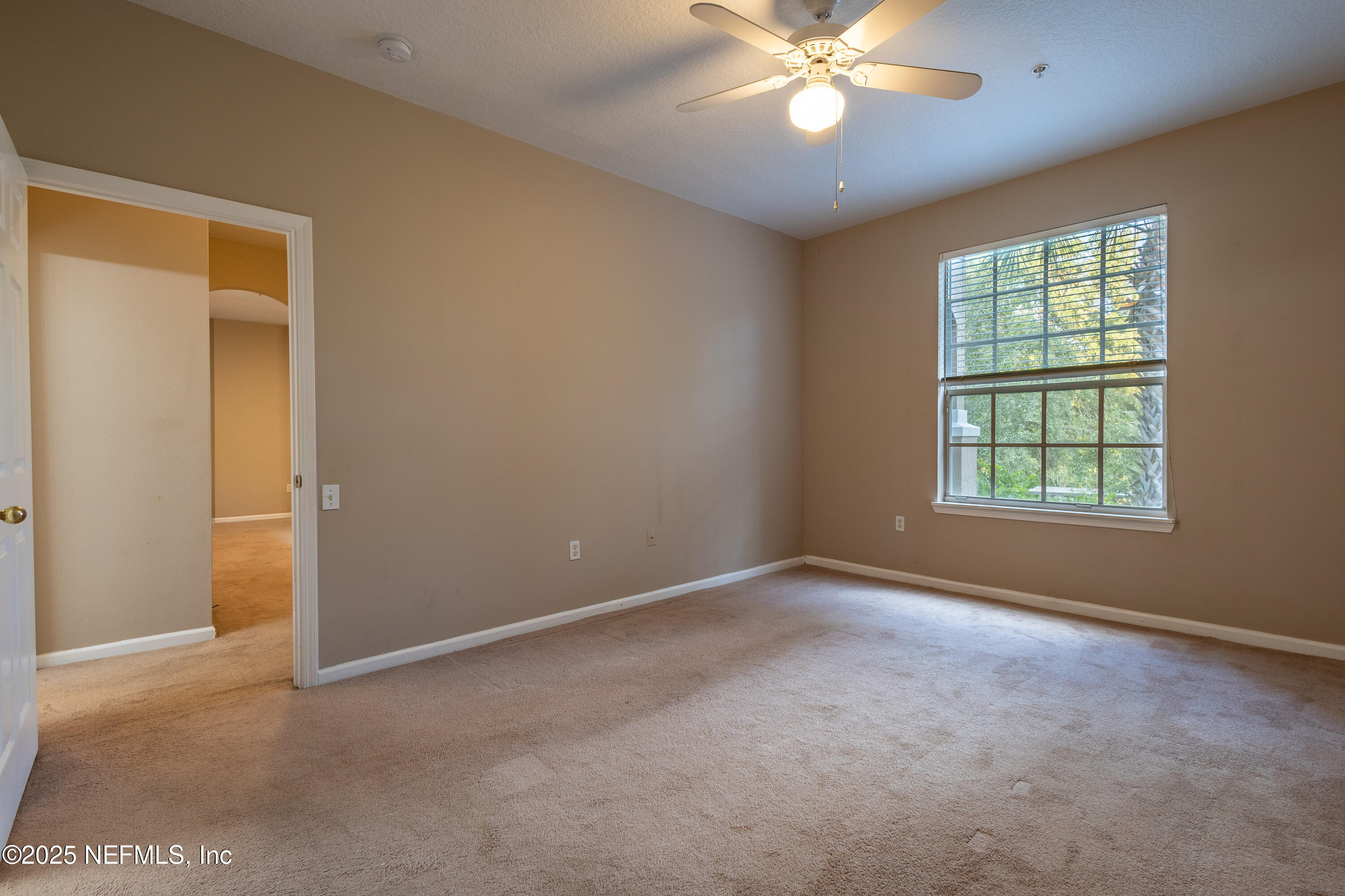 10550 Baymeadows Road, Unit 610 Jacksonville, FL 32256 - Photo 25 of 35 an empty room with a ceiling fan and a window