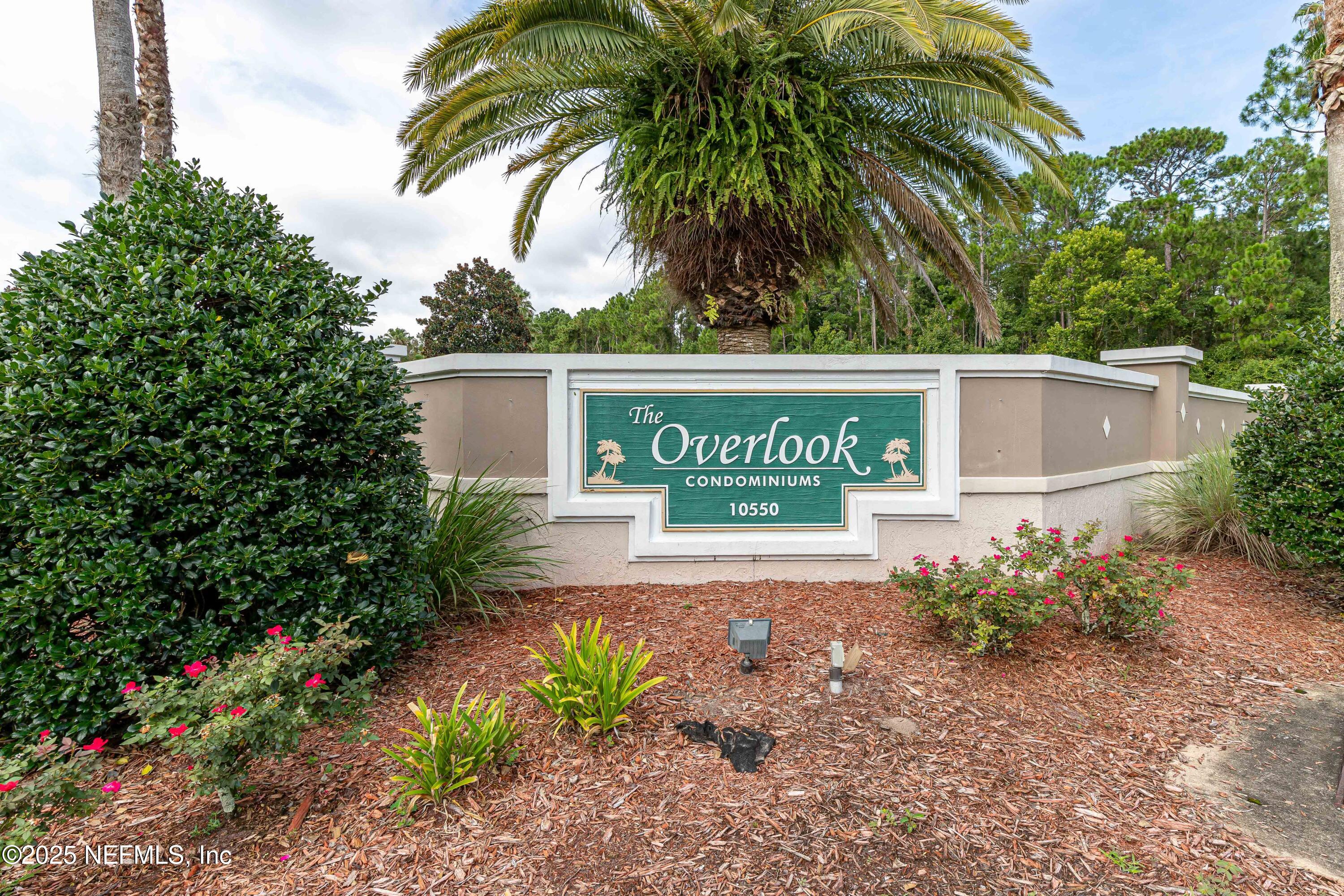10550 Baymeadows Road, Unit 610 Jacksonville, FL 32256 - Photo 32 of 35 a sign that is sitting in front of a house with potted plants
