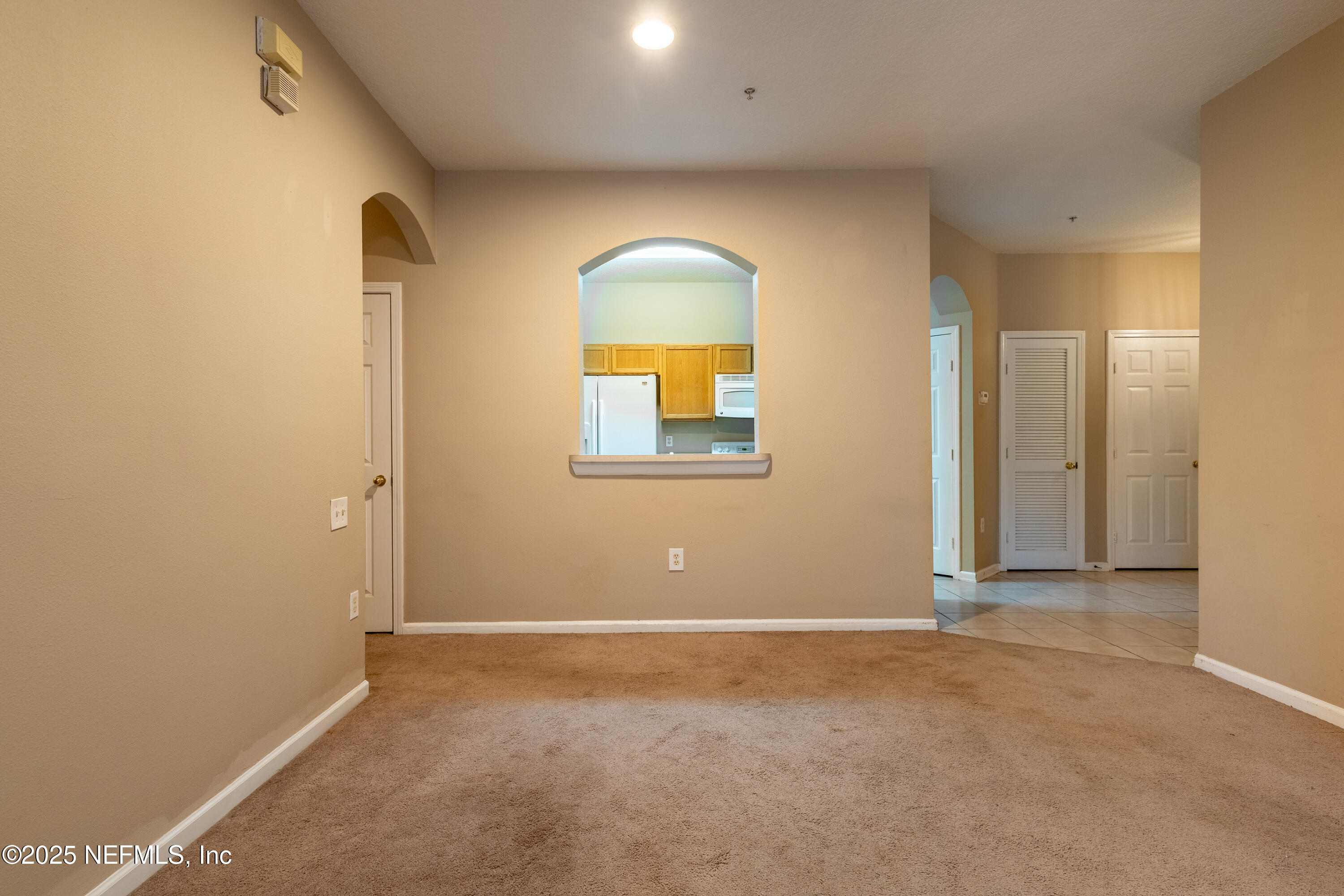 10550 Baymeadows Road, Unit 610 Jacksonville, FL 32256 - Photo 7 of 35 an empty room with a window and a mirror
