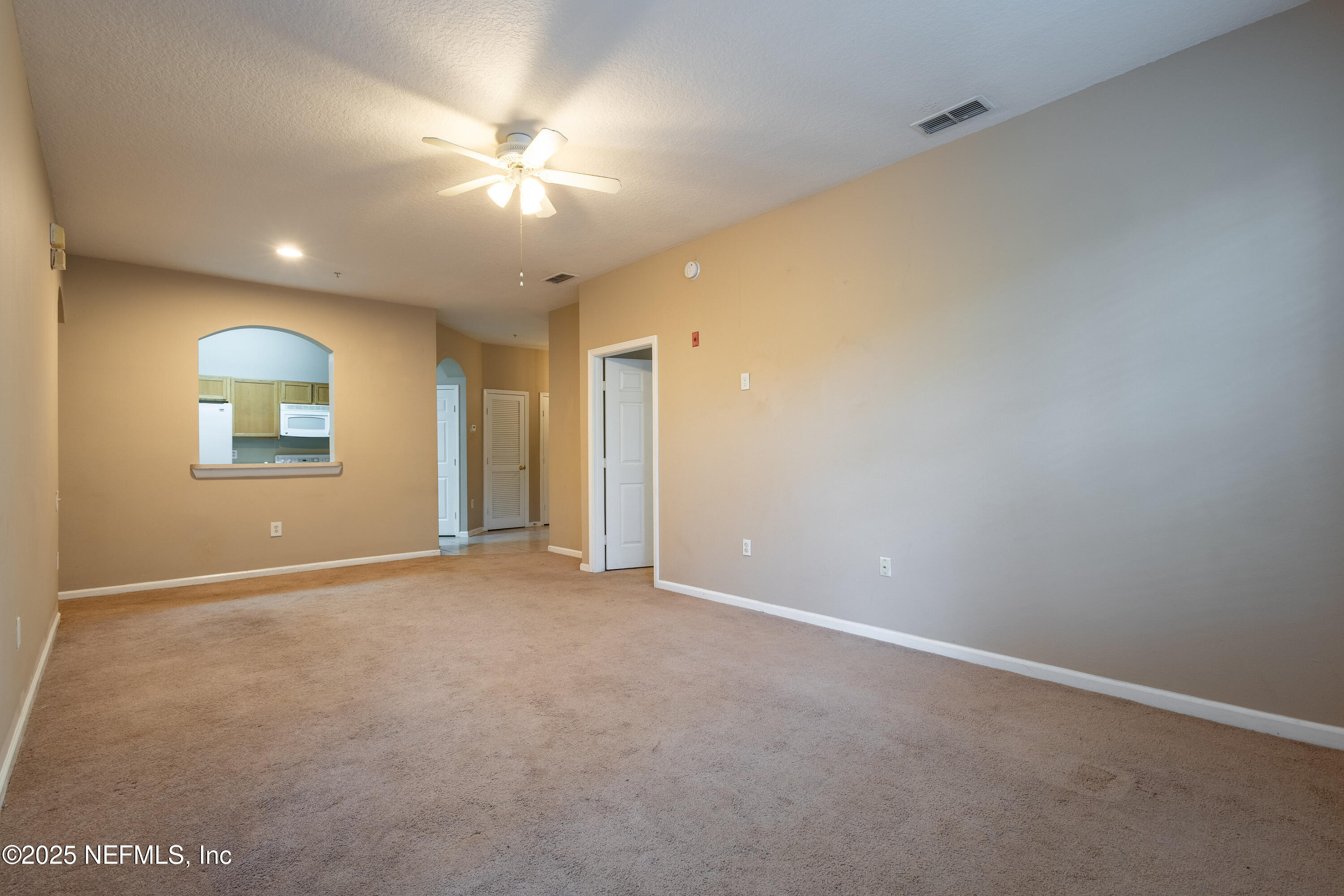 10550 Baymeadows Road, Unit 610 Jacksonville, FL 32256 - Photo 8 of 35 an empty room with a ceiling fan and window