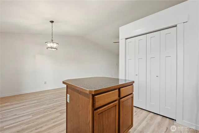 a utility room with wooden floor washer and closet