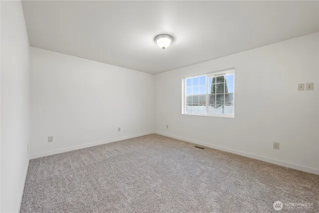 an empty room with a empty space and windows