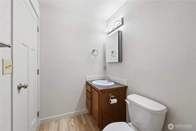 a bathroom with a toilet sink and mirror