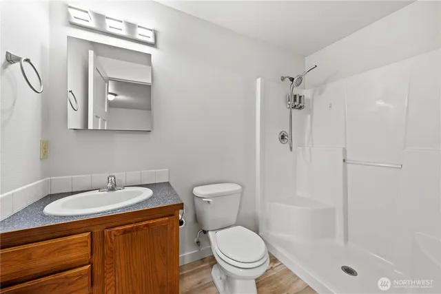 a bathroom with a sink toilet and shower