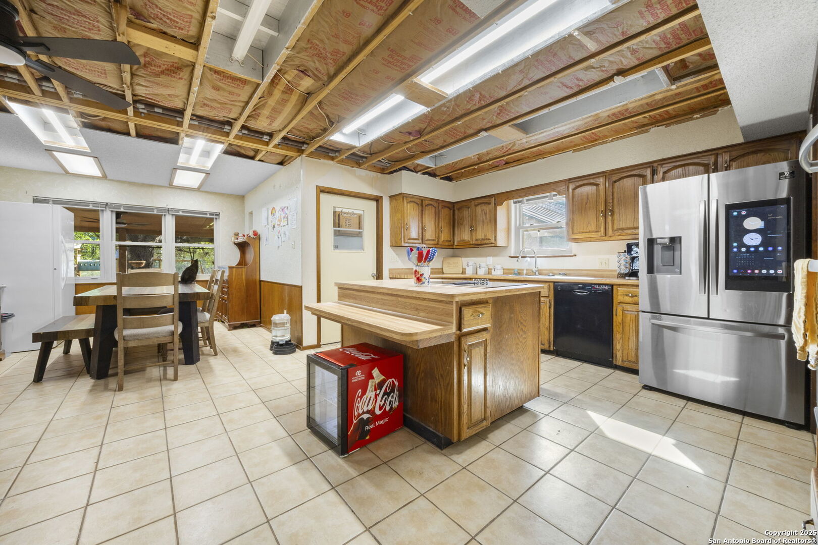 2452 2nd Street Pleasanton, TX 78064 - Photo 10 of 15 a kitchen with stainless steel appliances granite countertop a stove a sink and a refrigerator