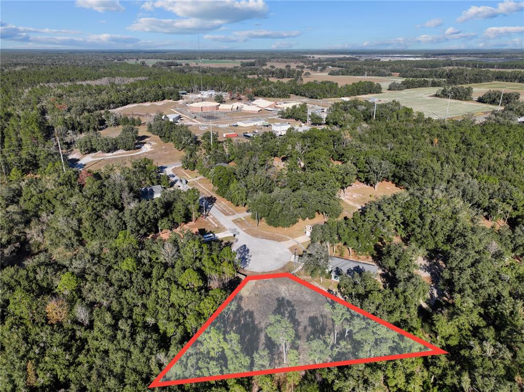 Undisclosed Address Bronson, FL 32621 - Photo 2 of 11 an aerial view of residential houses with outdoor space and seating