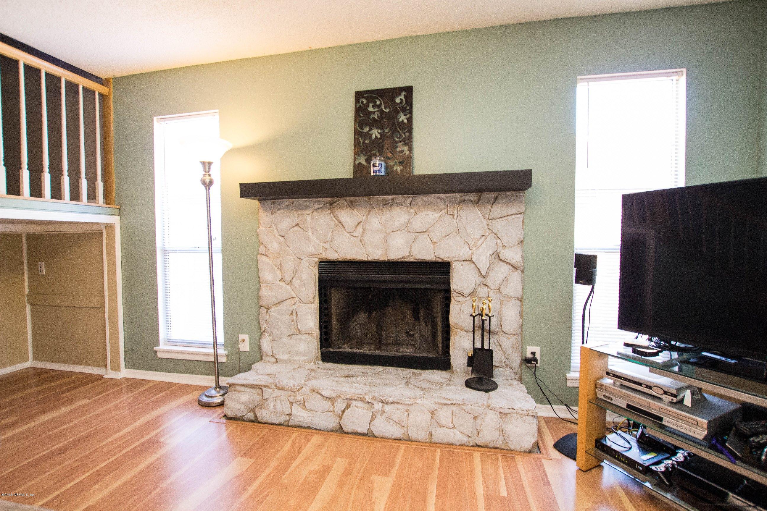 1609 Derringer Road Jacksonville, FL 32225 - Photo 13 of 33 a living room with furniture and a fireplace