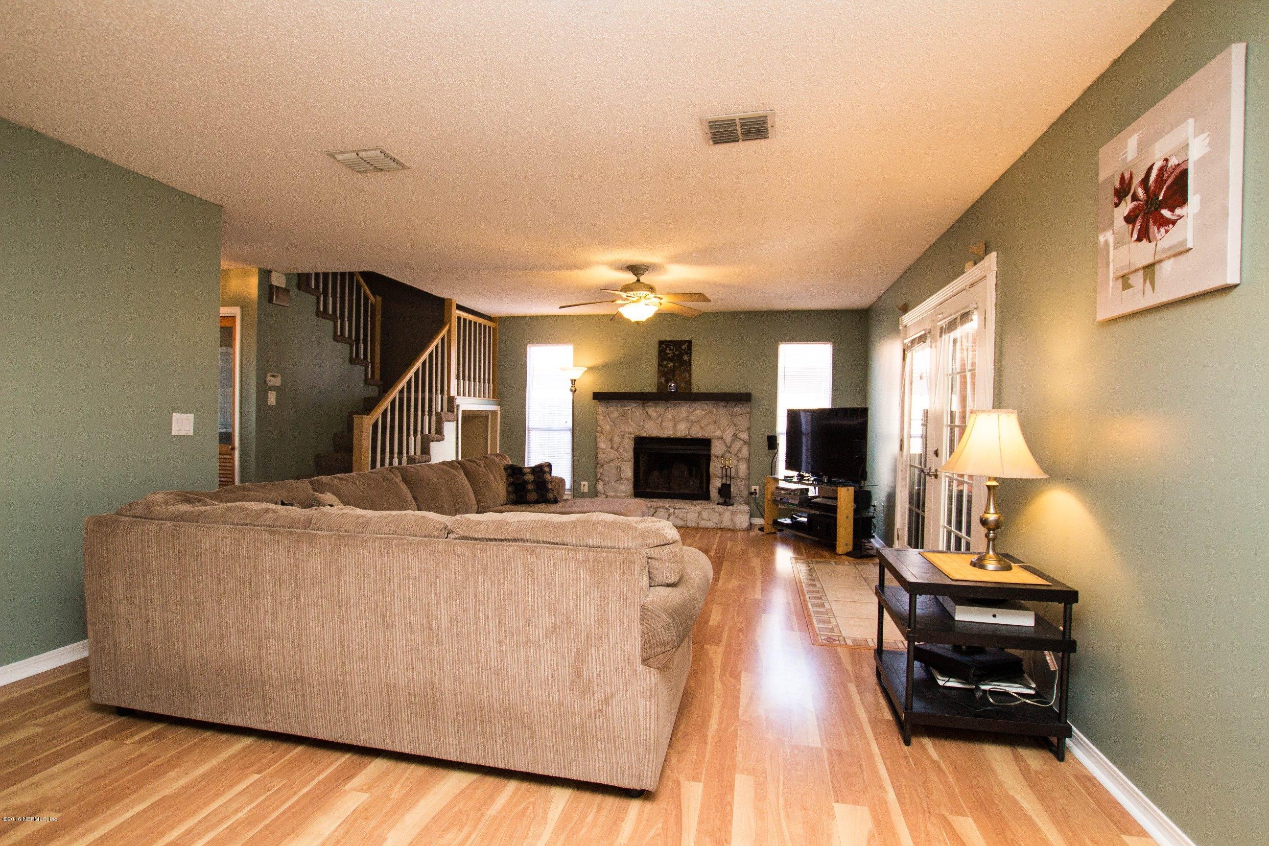 1609 Derringer Road Jacksonville, FL 32225 - Photo 14 of 33 a living room with furniture and a fireplace