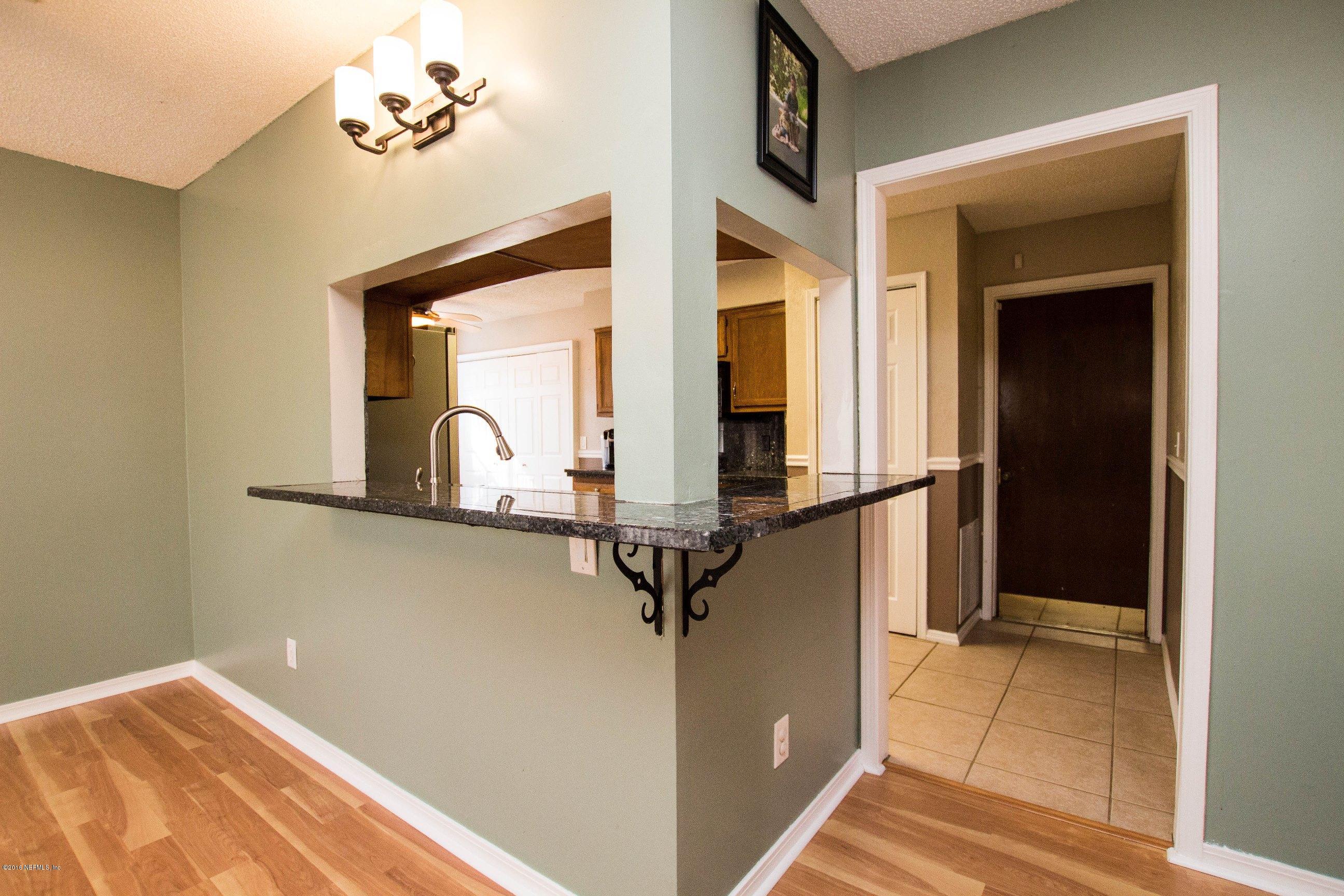 1609 Derringer Road Jacksonville, FL 32225 - Photo 17 of 33 a view of a hallway with paintings on the wall