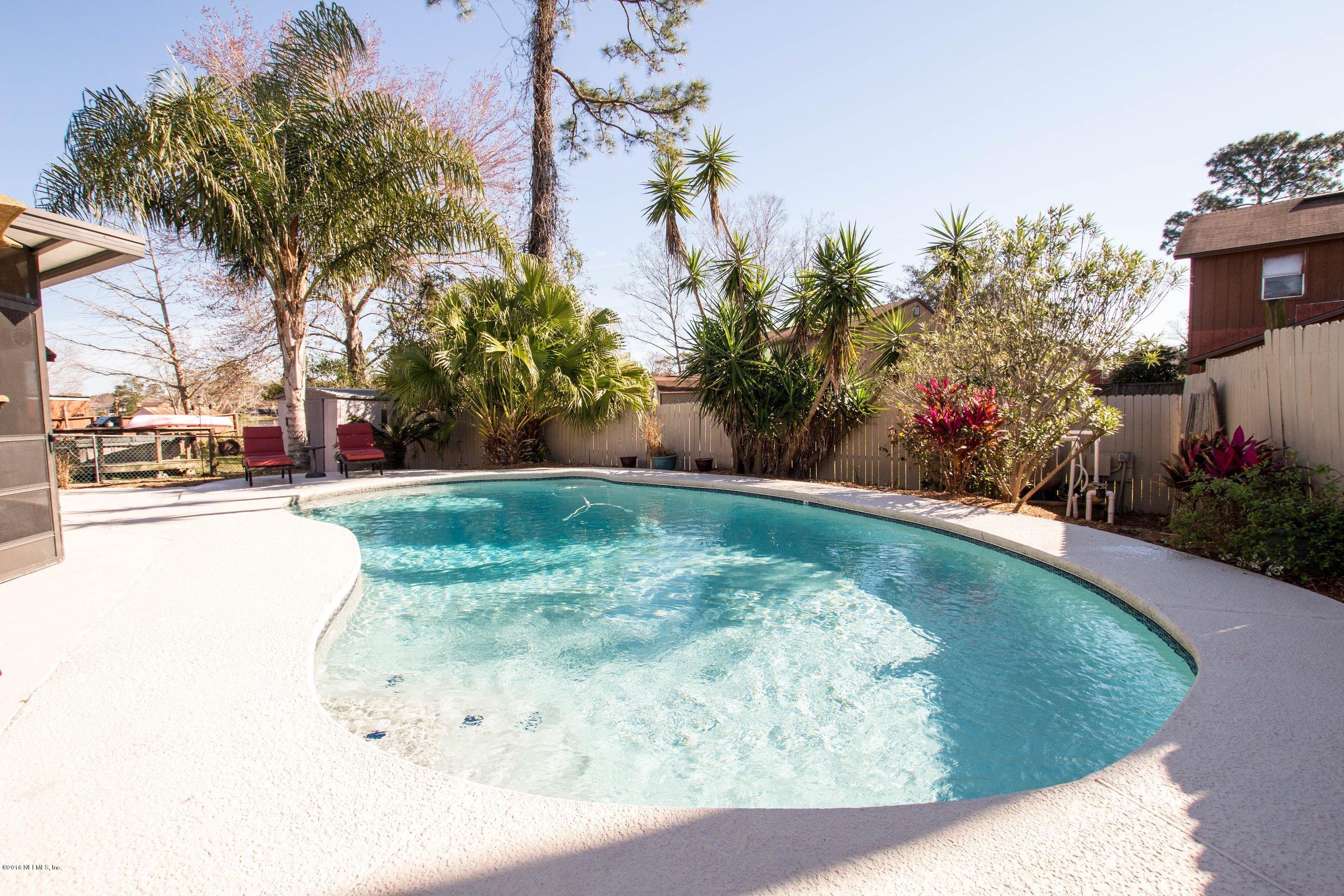1609 Derringer Road Jacksonville, FL 32225 - Photo 29 of 33 a view of a swimming pool with a yard