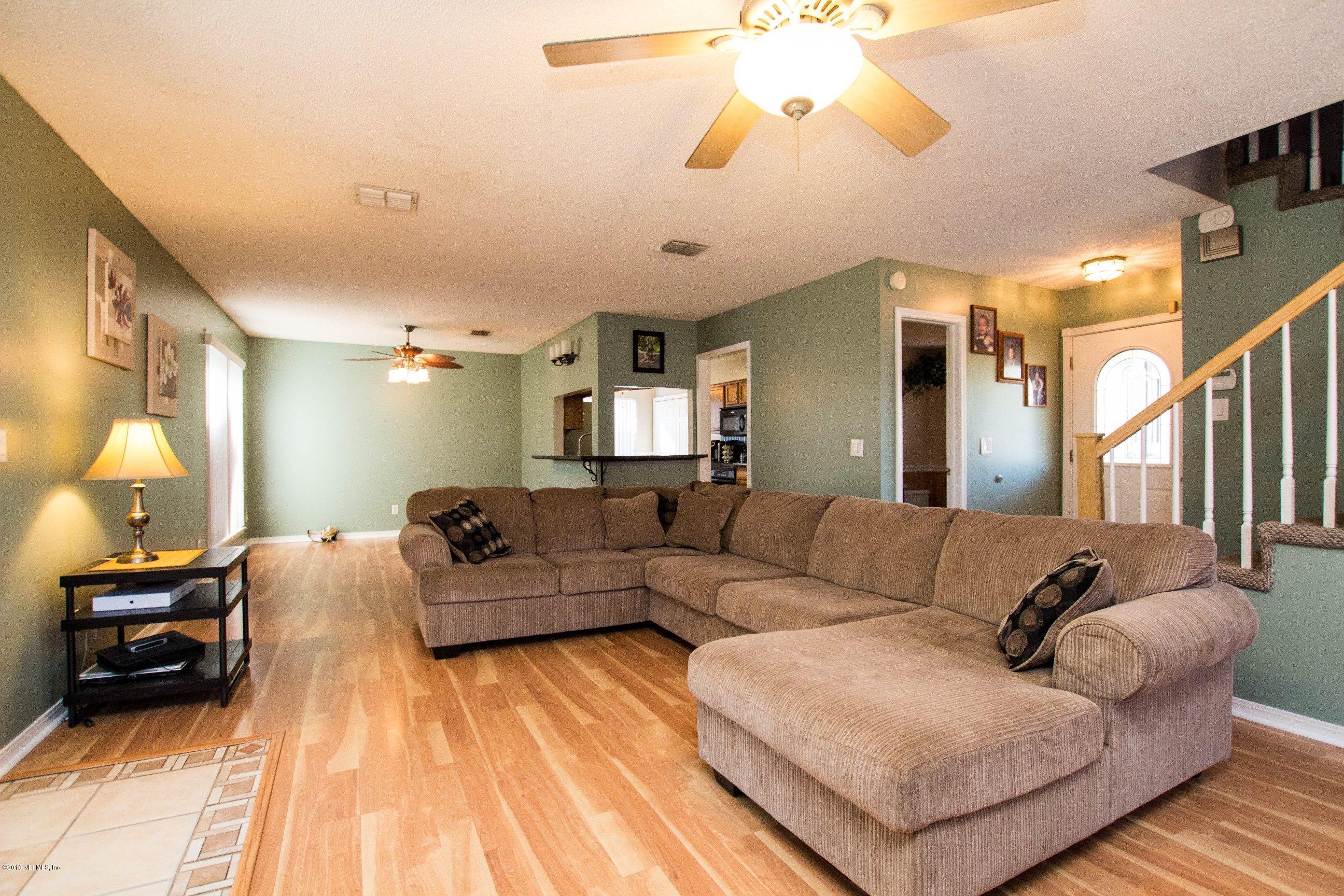 1609 Derringer Road Jacksonville, FL 32225 - Photo 3 of 33 a living room with furniture and a chandelier