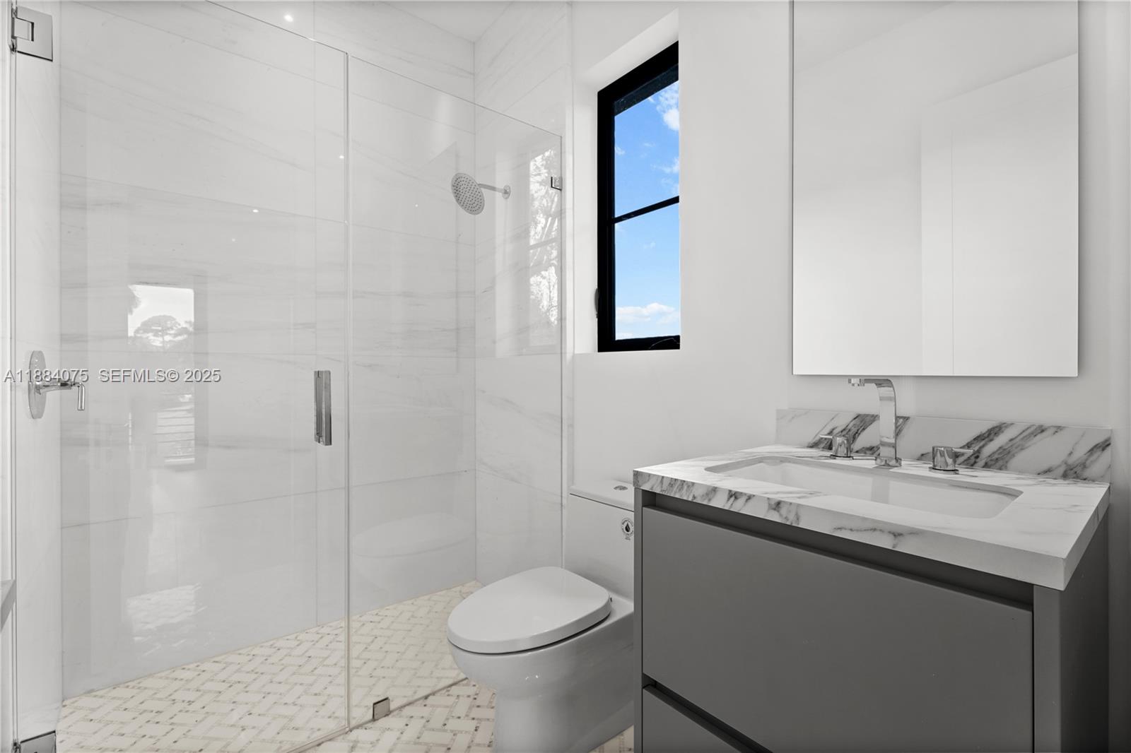 7001 Southwest 71st Avenue Miami, FL 33143 - Photo 21 of 50 a bathroom with a granite countertop sink toilet and shower