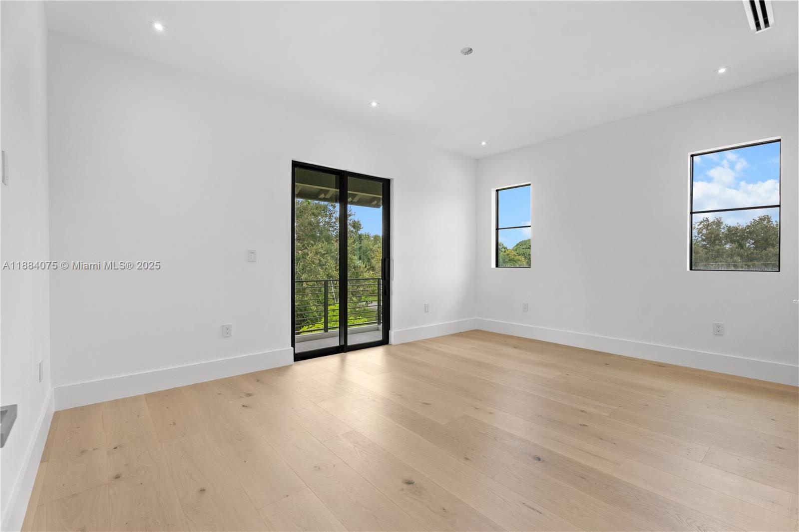 7001 Southwest 71st Avenue Miami, FL 33143 - Photo 22 of 50 an empty room with floor to ceiling window and hardwood floor