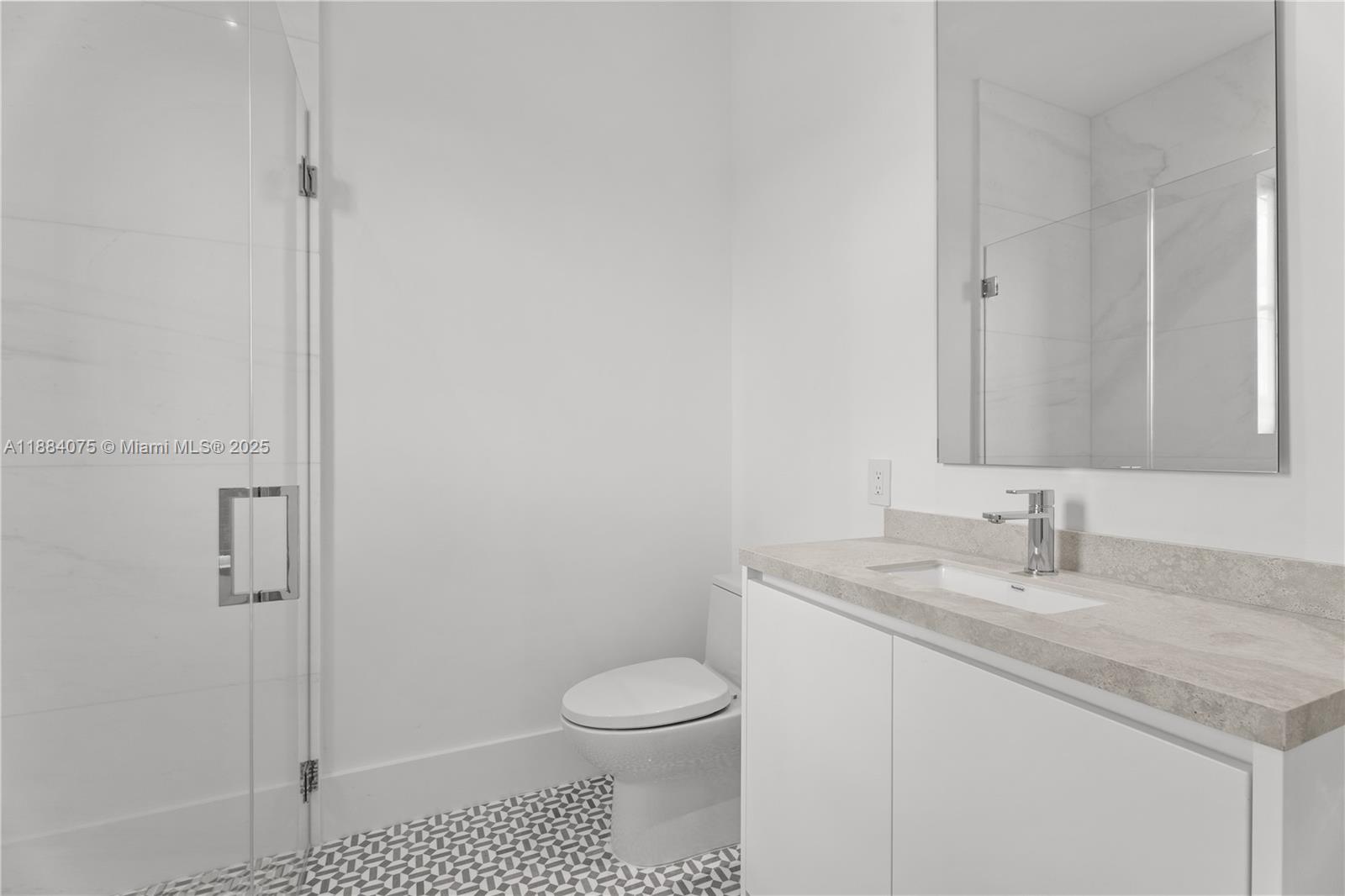 7001 Southwest 71st Avenue Miami, FL 33143 - Photo 23 of 50 a bathroom with a granite countertop sink a toilet and a mirror