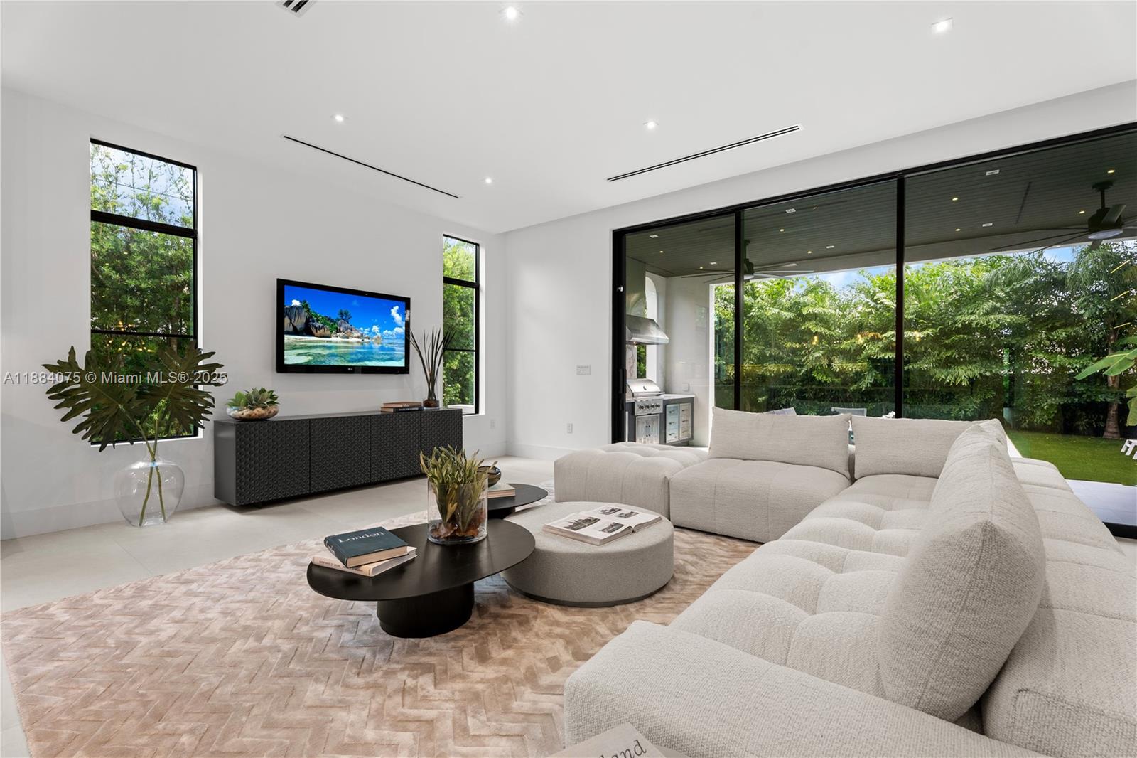 7001 Southwest 71st Avenue Miami, FL 33143 - Photo 32 of 50 a living room with furniture and a flat screen tv