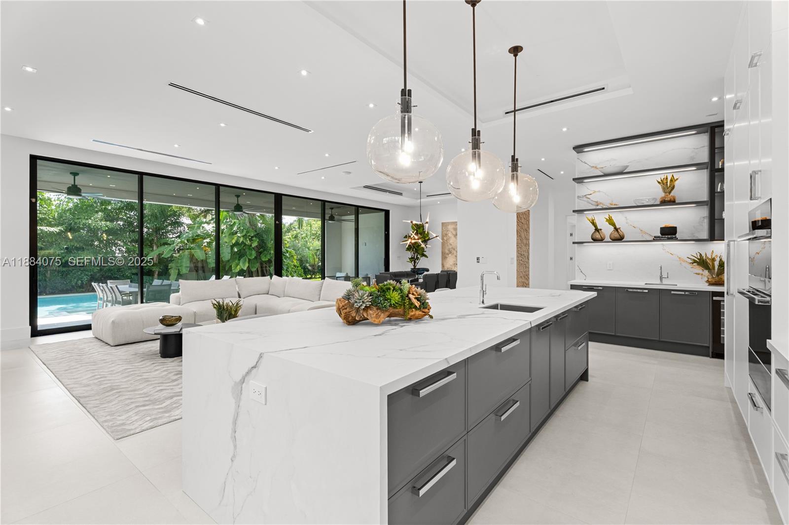 7001 Southwest 71st Avenue Miami, FL 33143 - Photo 4 of 50 a large white kitchen with a large window and stainless steel appliances