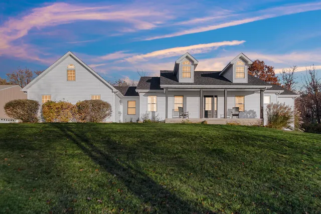 a spacious bedroom with a bed and a chandelier