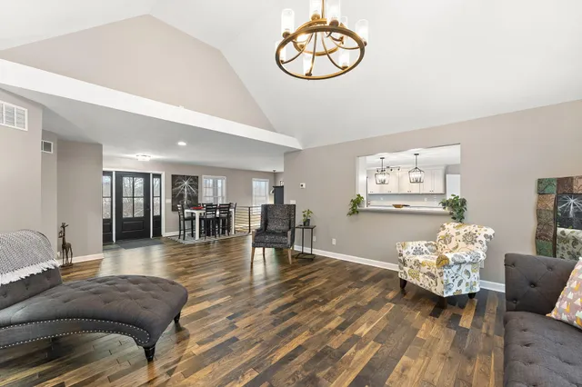 a view of a white house with a snow on the road