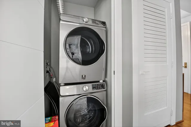 a kitchen with stainless steel appliances white cabinets and wooden floors