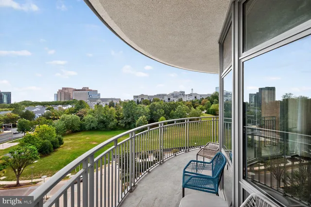 a view of a city with flower garden in front of it