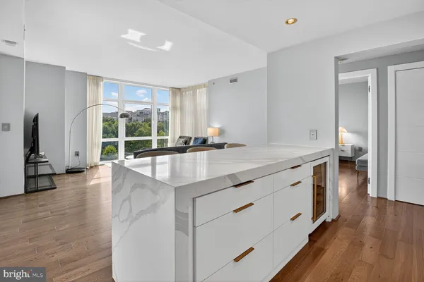 a kitchen with stainless steel appliances granite countertop a sink stove and wooden floor
