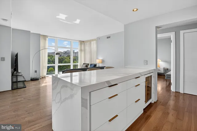 a kitchen with stainless steel appliances granite countertop a sink stove and wooden floor