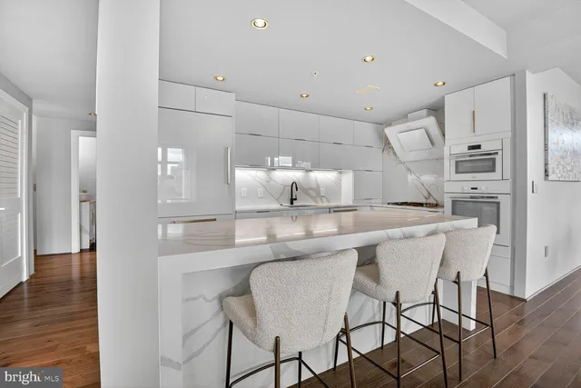 a kitchen with kitchen island cabinets and refrigerator