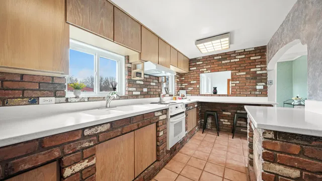 a large kitchen with a sink and cabinets