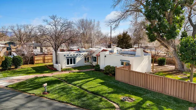a view of a house with backyard and sitting area