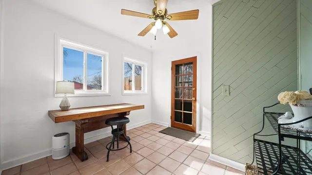 a room with lounge chair and windows