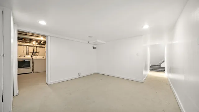 an empty room with a bathroom and a sink