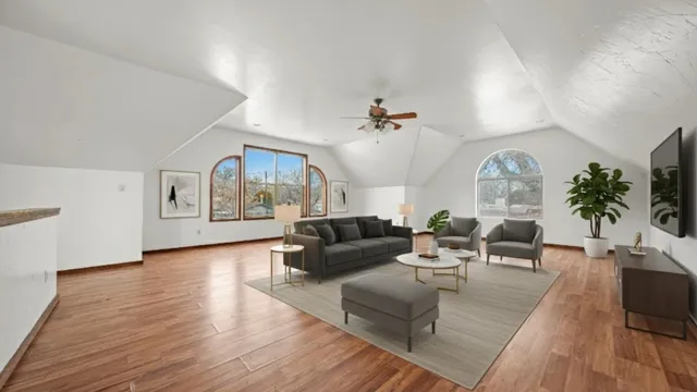 a living room with furniture and wooden floor