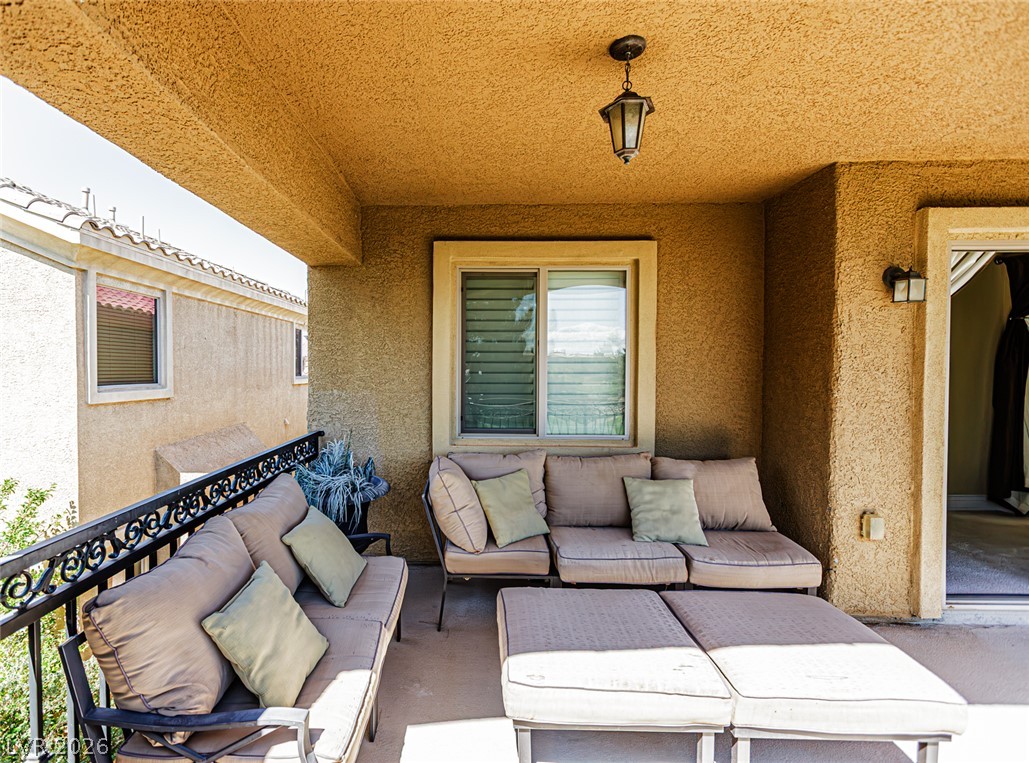 75 Tall Ruff Drive Las Vegas, NV 89148 - Photo 48 of 64 A covered outdoor area features textured walls and protective iron railings.
