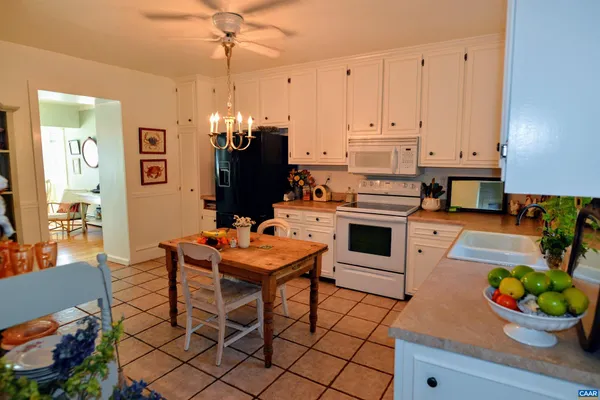 a kitchen with stainless steel appliances kitchen island granite countertop a stove a sink and a microwave