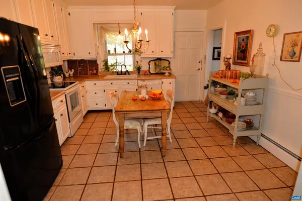 a dining room with stainless steel appliances kitchen island granite countertop a refrigerator and a stove