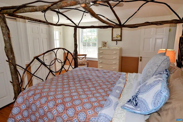 a bed room with a bed and wooden floor